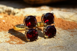 a four-stone gold plated ring with genuine garnet gemstones