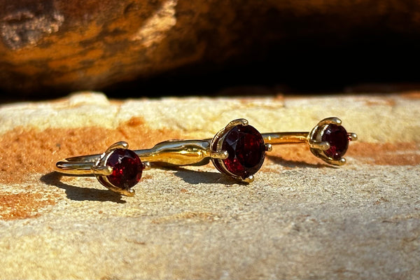 Side view of the Dainty garnet Gold 3cap ring 