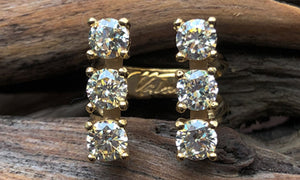 front view of a six-stone gold plated ring with clear CZ crystals 