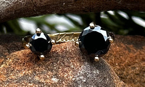 front view of a 14k gold plated ring with two black CZ  crystals