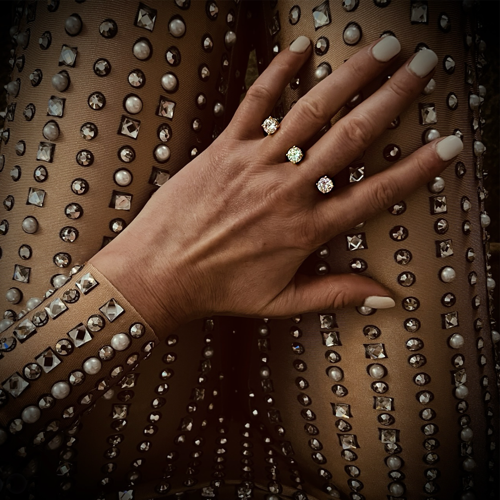 Hand with Valou cz 3cap  (double finger ring with CZ) on a sexy studded transparent bodysuit