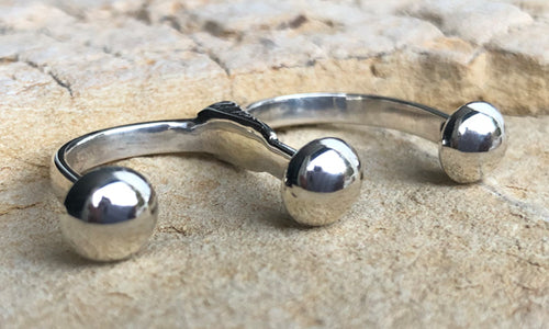 side view of the all silver double finger ring for women with three 8mm domes featuring a wide band